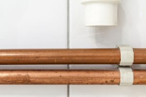 two copper pipes running parallel to each other