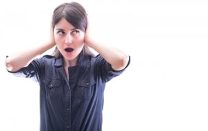 woman covering her ears, set against a white background