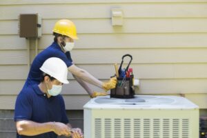 outside-unit-of-air-conditioner-with-techs-working