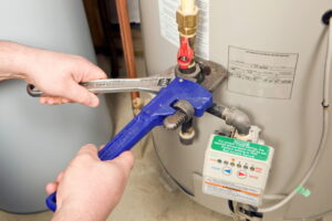 hands-working-on-gas-line-on-water-heater