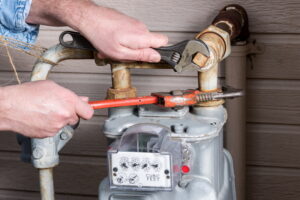 plumber-working-on-gas-lines-at-an-outdoor-gas-meter