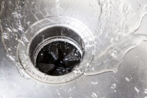 water-swirling-down-a-sink-with-a-garbage-disposal