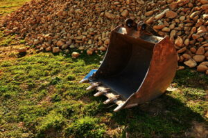 excavator-bucket-and-pile-of-rocks