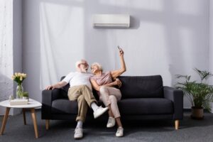 couple-relaxing-on-a-couch-in-front-of-a-ductless-air-handler