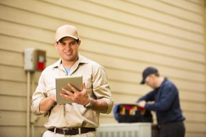 HVAC-technicians-repairing-an-AC-outdoor-unit